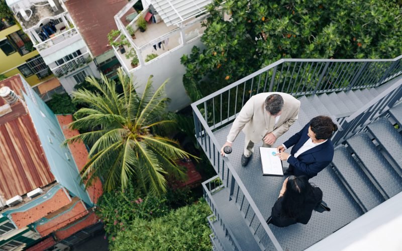 Finance department manager showing annual report to his colleagues, view from the top
